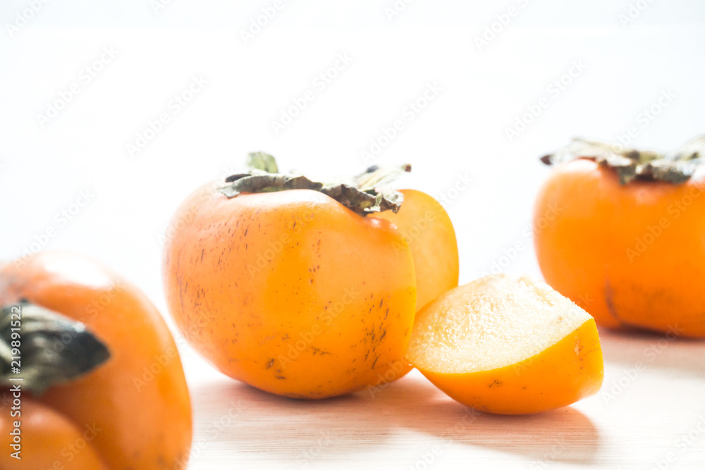 Persimmon on a white background, persimmon orange in front view Persimmon on a white background, persimmon orange in front view
