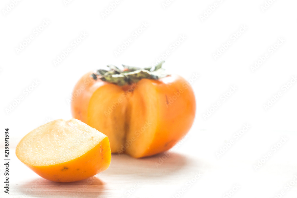 Persimmon on a white background, persimmon orange in front view