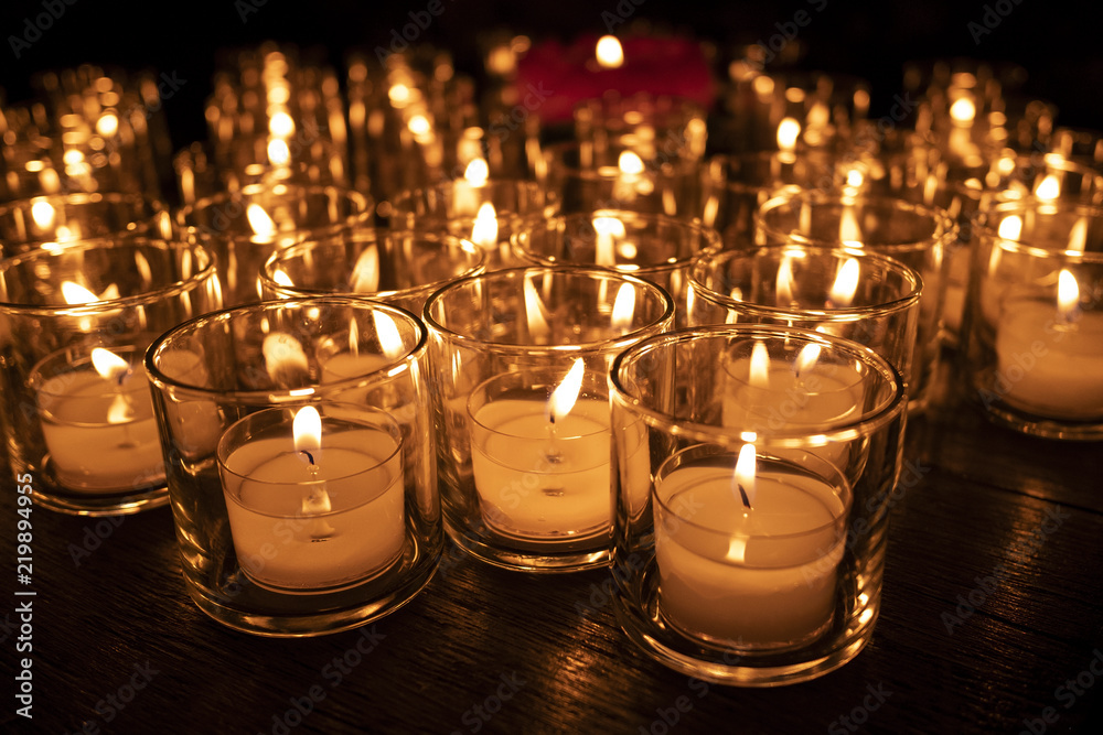 Lots of candle lights in the glasses for prayer. Lots of candle lights in the glasses for prayer.