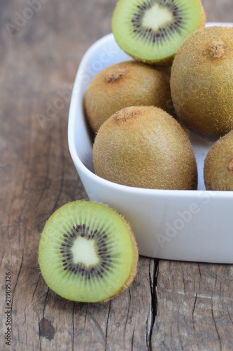 fresh kiwi fruits on wood background with copy space