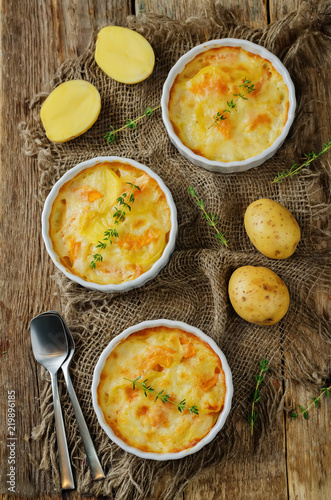 Pumpkin potato gratin with fresh thyme leaves photo