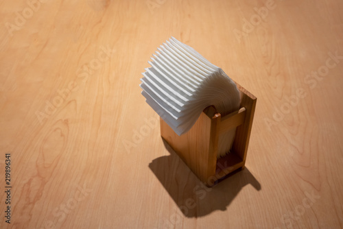 napkin paper in wooden box on wooden table