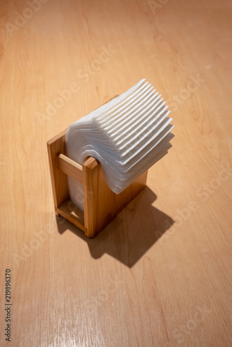 napkin paper in wooden box on wooden table