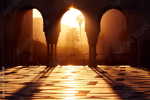 Great mosque of Hassan 2 at sunset in Casablanca, Morocco. Beautiful Arches of the Arab mosque in the sunset, sunlight rays