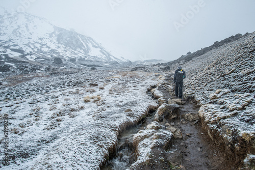 Tourist trekking on the steep hills to Annapurna base camp (4,130 metres) in Himalayas mountains range of Nepal during the snow storms.
 photo