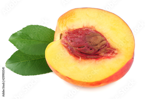 Nectarine with green leaf and slices isolated on white background.