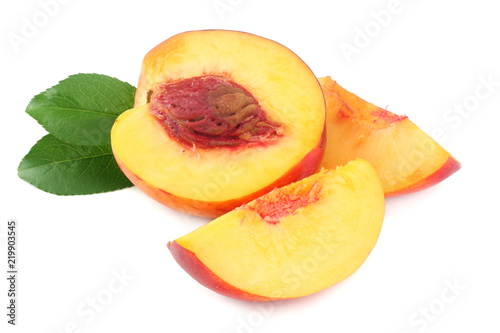 Nectarine with green leaf and slices isolated on white background.