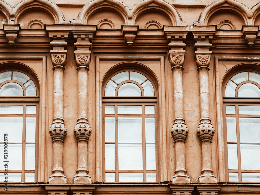 View of windows and details on an exterior of the medieval building in Saint Petersburg, Russia.