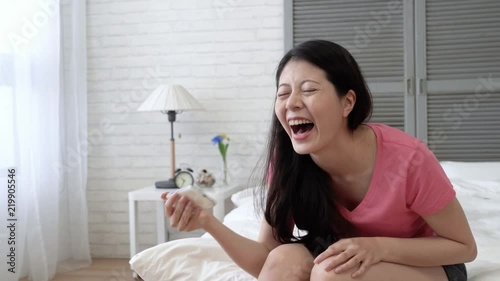woman laughing her bed and keep clapping