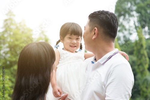 Outdoor portrait of Asian family.
