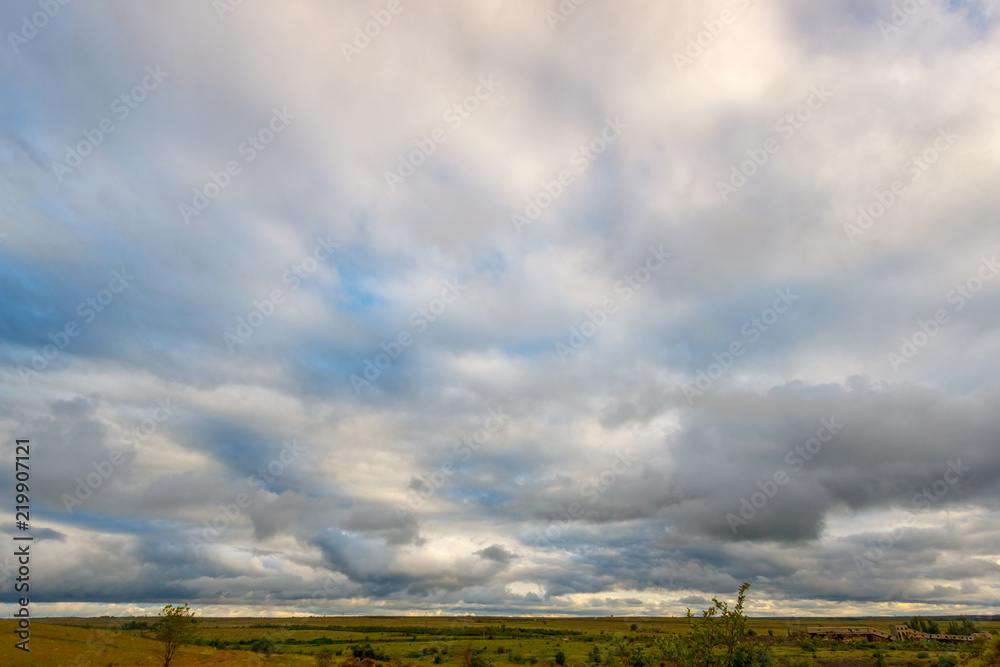 The sky with stormy clouds and clearances