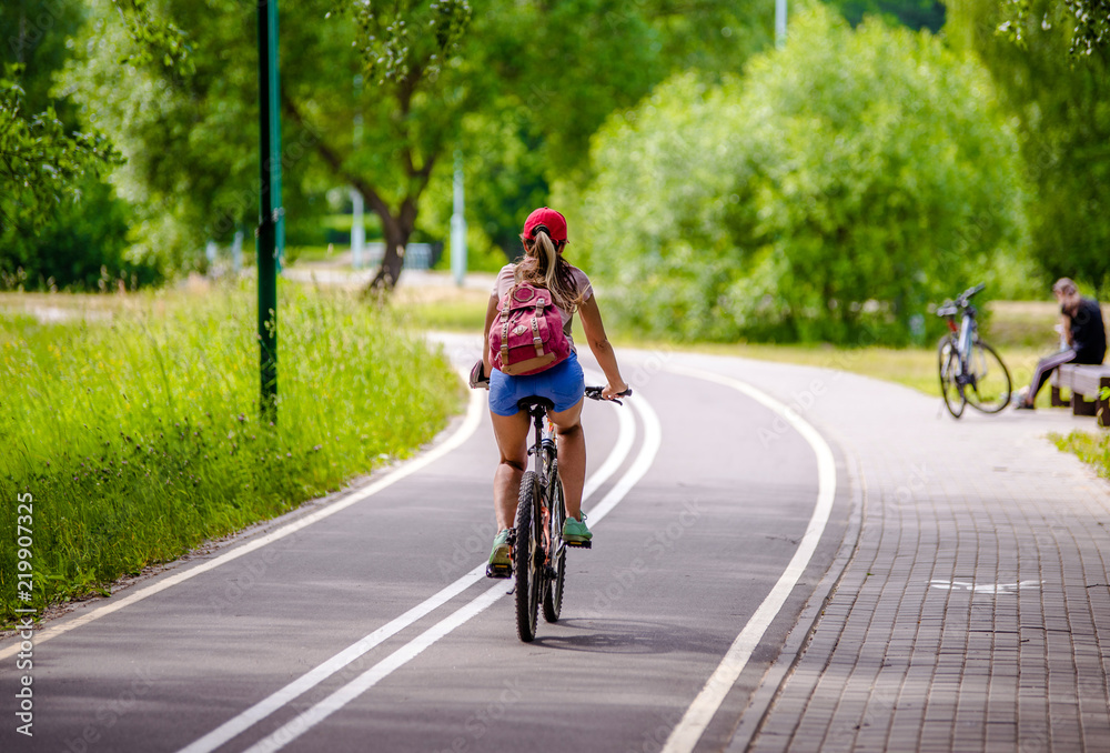 Girl riding a bike in the city Park 