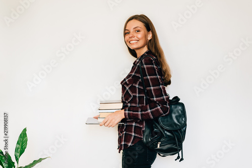 Pretty teen gild student of school or college with stack of books education photo