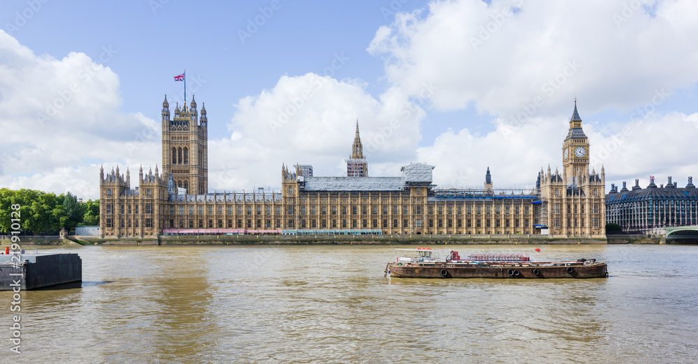 LONDON, UK - 15 Sep 2017: The Palace of Westminster, home of the UK parliament, sits on the banks of the Thames river in London, UK.