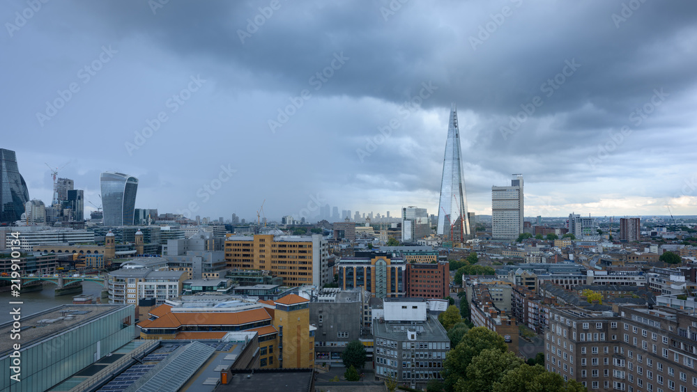 LONDON, UK - 15 Sep 2017: The Tate Modern Gallery tower is popular viewpoint in front of the Thames river, in London, UK. London City and the Shard residential tower appear in the background.