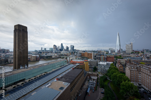LONDON, UK - 15 Sep 2017: The Tate Modern Gallery tower is popular viewpoint in front of the Thames river, in London, UK. London City and the Shard residential tower appear in the background.
