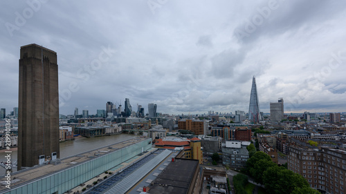 LONDON, UK - 15 Sep 2017: The Tate Modern Gallery tower is popular viewpoint in front of the Thames river, in London, UK. London City and the Shard residential tower appear in the background.