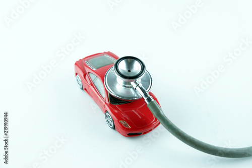 Stethoscope checking up the car on white background, Concept of car check up, repair and maintenance..