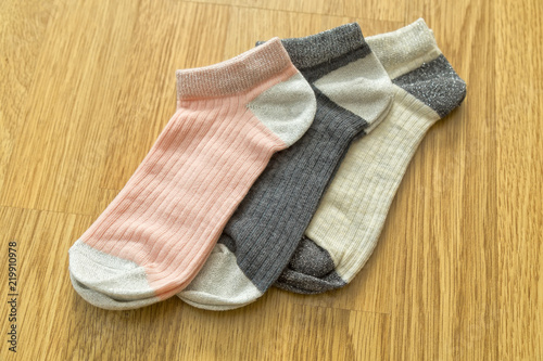 colorful socks on the wooden background.