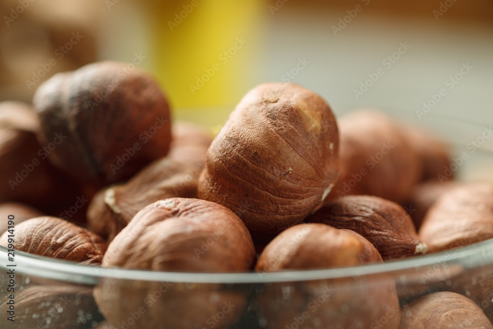 Fototapeta premium Hazelnut in glass bowl closeup shot, selective focus