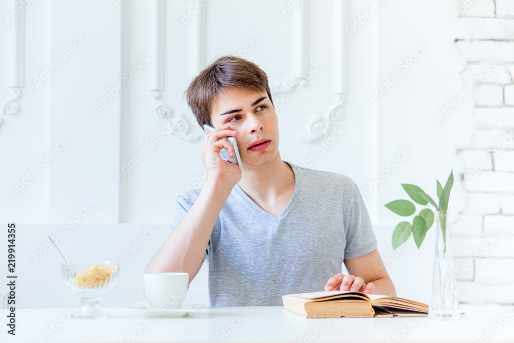Young man drinking coffee and having breakfast Young man drinking coffee and having breakfast