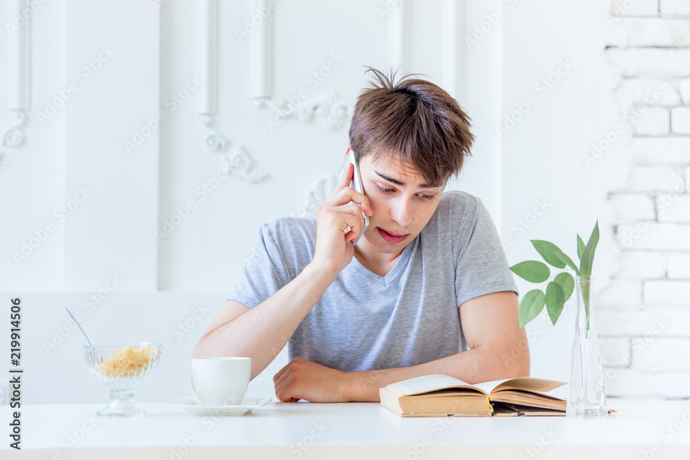Young man drinking coffee and having breakfast Young man drinking coffee and having breakfast