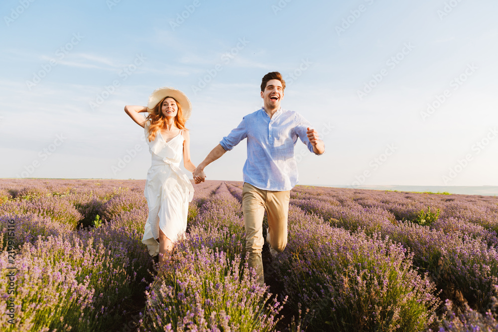 Happy young couple embracing at the lavender field Happy young couple embracing at the lavender field