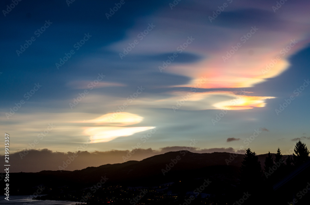 Polar stratospheric clouds over small town in twilight