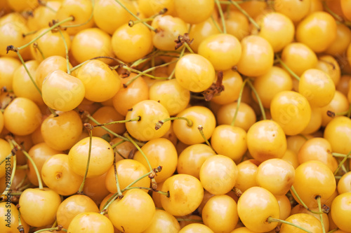 Lot of ripe yellow cherries in the supermarket.