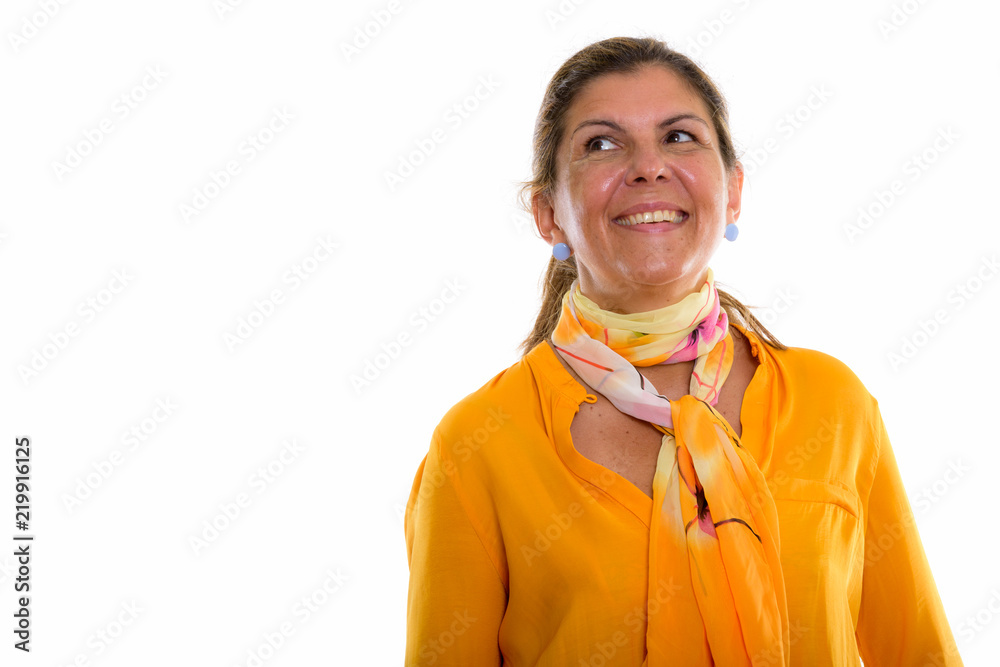 Studio shot of mature happy businesswoman smiling and thinking w