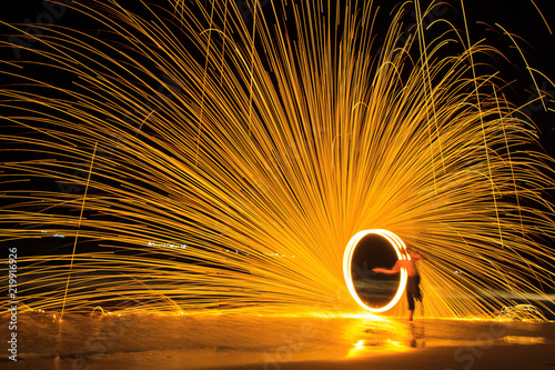 A male fire dancer on the beach