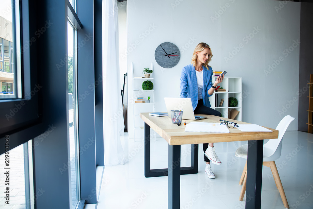 Beautiful business lady smiling while working in office