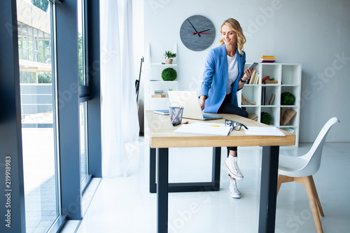 Beautiful business lady smiling while working in office