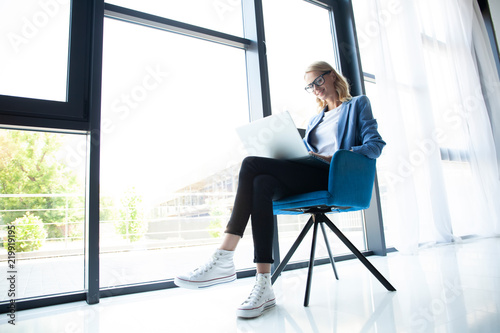 Hipster Woman use Laptop huge Loft Studio.Student Researching Process Work.Young Business Team Working Creative Startup modern Office.Analyze market stock,new strategy.Blurred,film effect.Horizontal © opolja