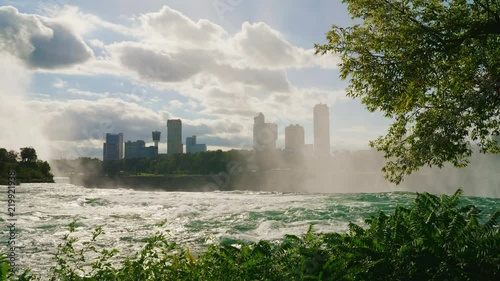The Niagara River in front of the waterfall. It is visible the Canadian coast with buildings of hotels and the entertaining centers for touris photo