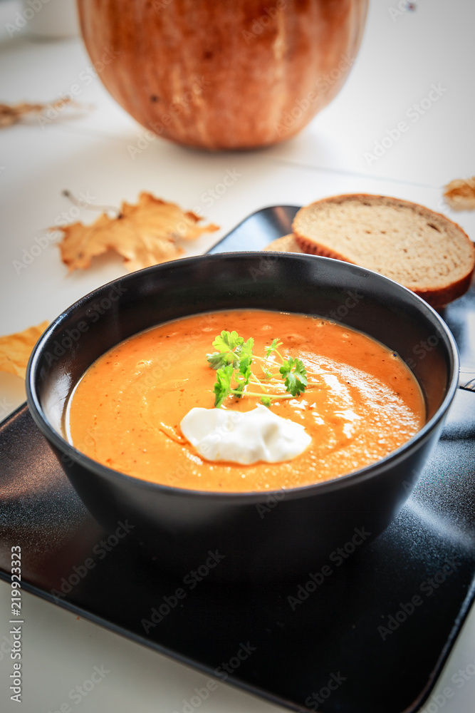Pumpkin and carrot soup with cream and parsley Pumpkin and carrot soup with cream and parsley