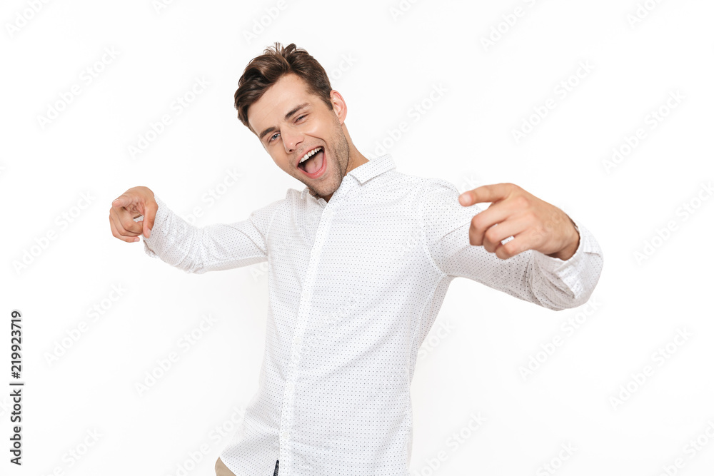 Image of positive guy 30s laughing and pointing fingers at camera like hey you, isolated over white background Image of positive guy 30s laughing and pointing fingers at camera like hey you, isolated over white background