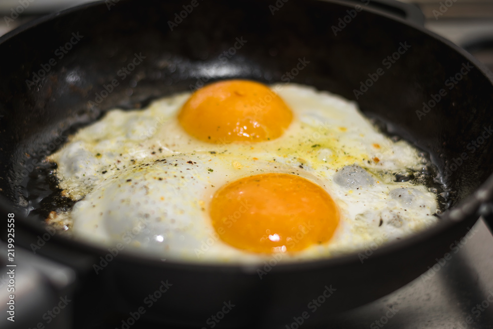 two eggs cooked in a black cast iron skillet two eggs cooked in a black cast iron skillet