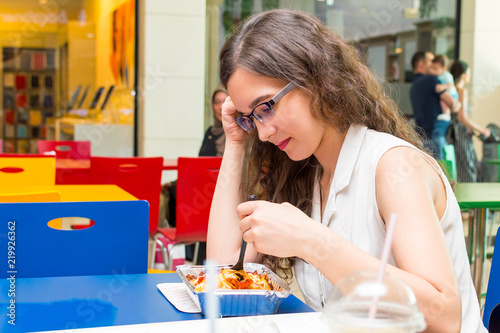 young woman eating in cafe
