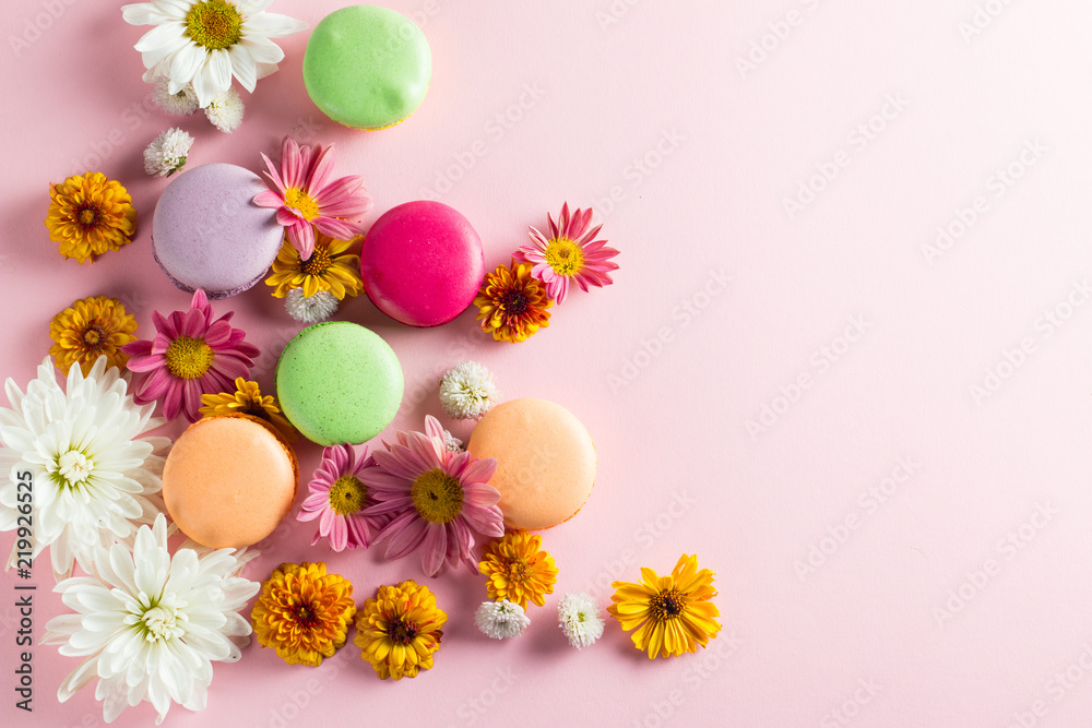 Still life and food photo of cake macarons in a gift box with flowers, a cup of tea on light background. Sweets and desserts concept of macaroons. Still life and food photo of cake macarons in a gift box with flowers, a cup of tea on light background. Sweets and desserts concept of macaroons.