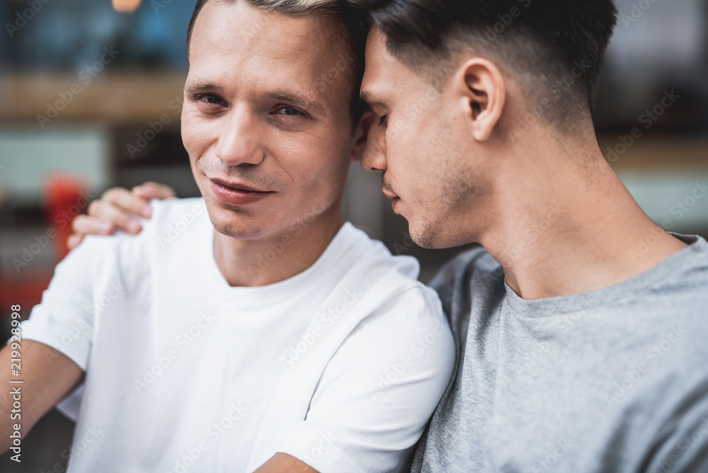 Everything is good. Do not be sad. Orderly man embracing smiling friend during conversation. Close friendship concept Everything is good. Do not be sad. Orderly man embracing smiling friend during conversation. Close friendship concept