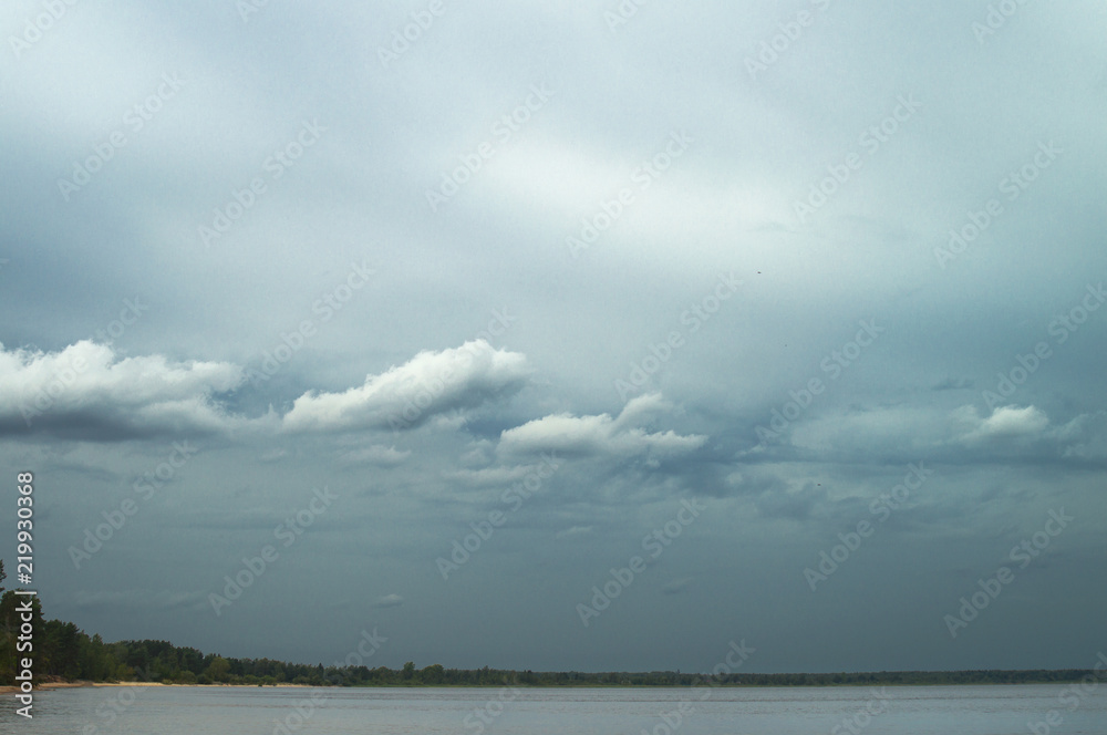 Gloomy blue gray sky and clouds over Lake Ladoga. Stormy sea weather