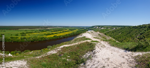 Landscape in the valley of the Don River in central Russia. Top view of the spring coastal forest and pond.