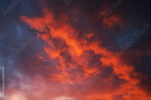 red cumulus clouds illuminated by the setting sun in the evening