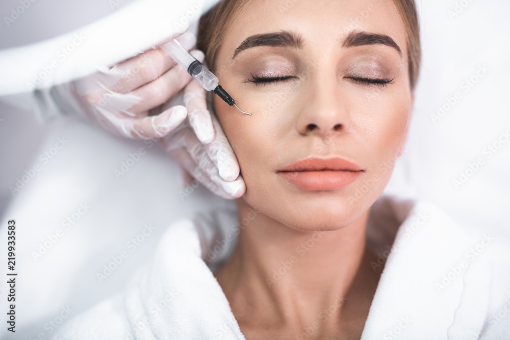 © Yakobchuk Olena - Clean skin. Close up portrait of attractive young lady with closed eyes. Girl getting injection in cheek