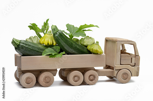 Truck with pattypan squash and squash. Children's wooden toy.