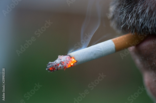 Man smoking a cigarette. Cigarette smoke spread. Healthy lifestyle