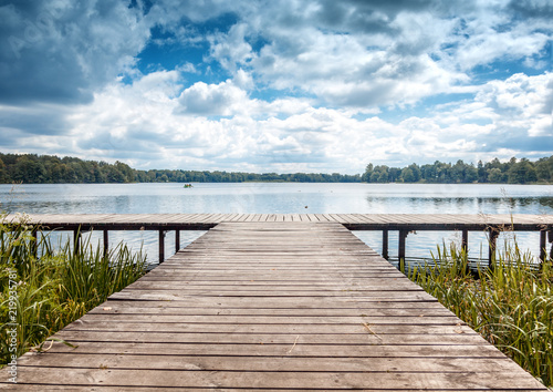 Beautiful summer landscape with dramatic sky, wooden pier on the lake, Trakai, Lithuania