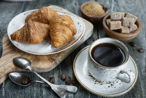 Cup of black coffee and cro...