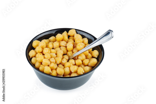 Ceramic bowl full of boiled chickpeas isolated on white background